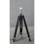 A Made.com black and chrome camera tripod design floor lamp. Height adjustable. H.99 W.59CM (