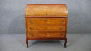 A Continental style kingwood cylinder top bureau, the floral inlaid top enclosing fitted interior