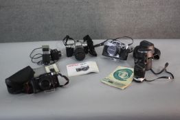 A Miranda Sensorex camera and a Pentax MZ-50 camera along with other cameras and accessories. H.9