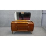 A vintage teak Austinsuite dressing table with tambour shutter revealing fitted well section