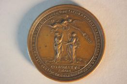 An 18th century bronze marriage medal. One side with a palm tree with two heraldic shields and the