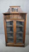 A late 19th century oak bookcase with fret carved Arts and Crafts motif decoration. H.170 W.84 D.