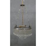 An early 20th century French silver plated crystal drop three tier waterfall chandelier, with four