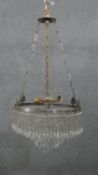 An early 20th century French silver plated crystal drop three tier waterfall chandelier, with four