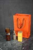 Three Hermes Caleche (empty) cosmetic bottles with original orange Hermes bag.