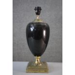 A black enamel and brass urn design lamp on square stepped base. H.46 W.16cm.