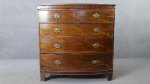 A Georgian mahogany bow fronted chest of drawers with crossbanded and satinwood strung top on