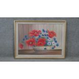 A framed oil on canvas still life of poppies and other flowers. Signed B. Storz. H.58 W.79 cm