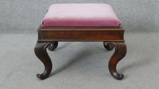 An early 19th century mahogany footstool with drop in seat on carved cabriole supports. H.35 W.50