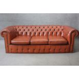 A three seater Chesterfield sofa in deep buttoned and studded leather upholstery. H.64 W.200 D.90