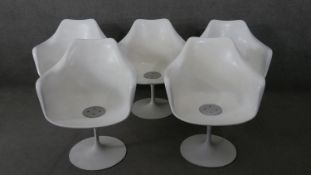 A set of five vintage Eero Saarinen style 'Tulip' dining armchairs with moulded seats on swivel