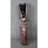 A set of golf clubs. Callaway woods, bladed Par Excellence irons and a putter in a Dunlop golf bag.