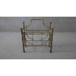 A vintage gilt metal magazine rack with gilt wood finials. H.57 W.47 D.20cm.