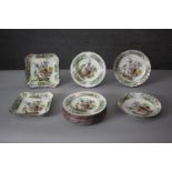 A part Spode peacock design dinner service. Includes nine dinner plates, two serving dishes and
