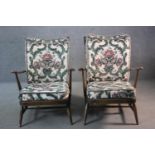 A pair of vintage Ercol 'model 403' beech framed armchairs in cut floral upholstery.