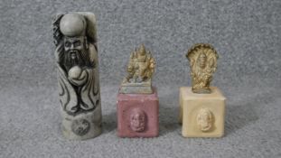 A carved Chinese soapstone chop in the form of an immortal along with two Indian brass deities on