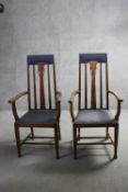 A pair of late 19th century oak armchairs with Art Nouveau tulip motif carved back splats.