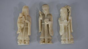 Three early 20th century carved soapstone Chinese figures of immortals. H.12 W.4cm (largest)