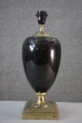 A black enamel and brass urn design lamp on square stepped base. H.46 W.16 cm.