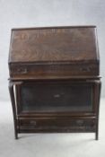 A Globe-Wernicke oak bureau with bookcase section to the base with maker's label. H.112 W.87 D.11