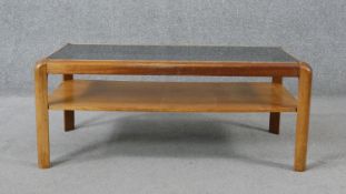 A mid century teak Nathan Furniture coffee table with smoked glass top and under tier. H.35 W.86 D.