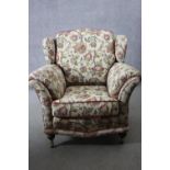 A 19th century armchair in floral tapestry style upholstery on turned mahogany supports