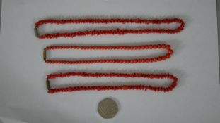 Three 19th century coral necklaces. One comprised of seventy five graduated round beads with a