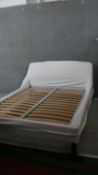 A King size double bed with slatted base and fitted headboard on tapered legs. To fit a 5' mattress.