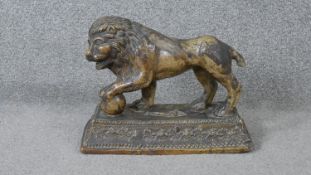 An early 19th century Staffordshire pearlware ceramic lion with ball, sitting on a rectangular