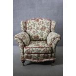 A 19th century armchair in floral tapestry style upholstery on turned mahogany supports