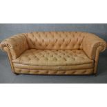 A Chesterfield sofa in studded and deep buttoned leather upholstery on bun feet. H.80 W.190 D.