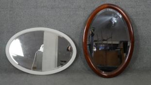 An early 20th century mahogany framed wall mirror with bevelled plate and a similar painted