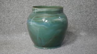 A vintage green, blue, white and brown marbled glaze bulbous vase with gilded rim. Stamped Cliff. to