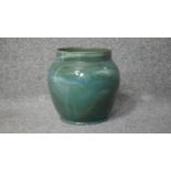 A vintage green, blue, white and brown marbled glaze bulbous vase with gilded rim. Stamped Cliff. to