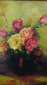 A gilt framed oil on board of a vase of roses. Signed Stan Butler. H.47 W.39cm