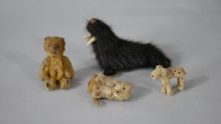 A collection of toys. Including a 1930's yellow miniature Schuco mohair bear lipstick holder, a pipe