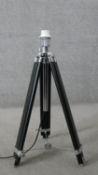 A Made.com black and chrome camera tripod design floor lamp. Height adjustable. H.99 W.59CM (