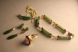 A gilded metal Chinese spinach jade necklace, bracelet and earring set along with a purple paste and