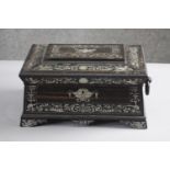 A 19th century Coromandel and mother of pearl inlaid sarcophagus sewing box with paper lined lift
