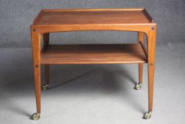 A mid century Danish teak trolley by Kurt Ostervig with two tiers on wheel casters. H.61 W.70 D.