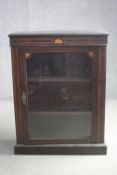 A Victorian mahogany pier cabinet with satinwood inlaid stringing and fan patera on a plinth base.