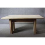 A contemporary light oak planked top dining table on block supports. H.74 W.160 D.100 cm.