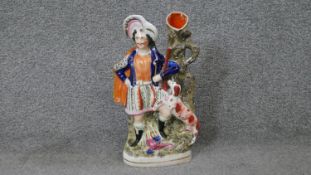 A 19th century Staffordshire pearlware flatback spill vase of a highlander and his spaniel. H.34 W.