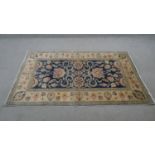 A Chubi rug with scrolling foliate decoration on a sapphire ground within floral multiple borders.