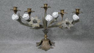A brass and ceramic five branch candelabra with rose and lily design and on a foliate base. H.32 W.
