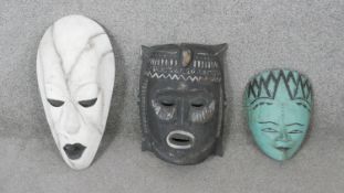 Three carved hardwood African tribal masks. H.44 W.25cm (largest)