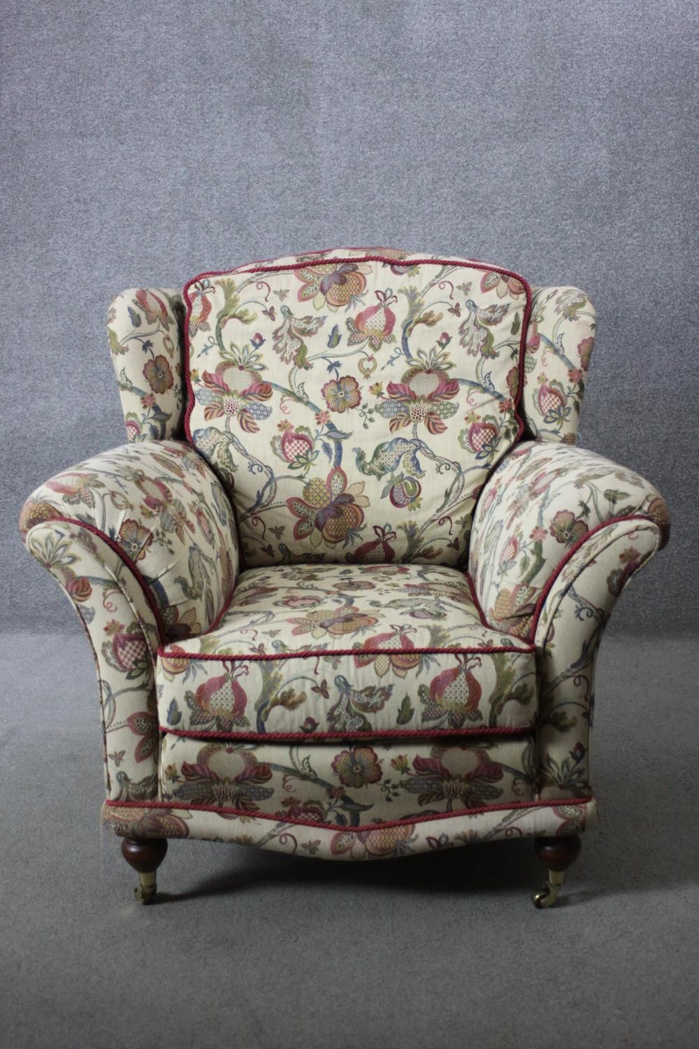 A 19th century armchair in floral tapestry style upholstery on turned mahogany supports