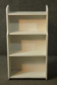 A vintage white painted open bookcase. H.84 W.45 D.16cm.