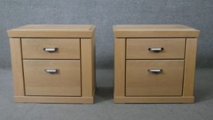 A pair of contemporary light teak bedside chests. H.56 W.62 D.41cm