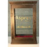 A vintage painted pine table top display cabinet later painted; Asprey Jewellers. H.64 W.38 D.38cm.